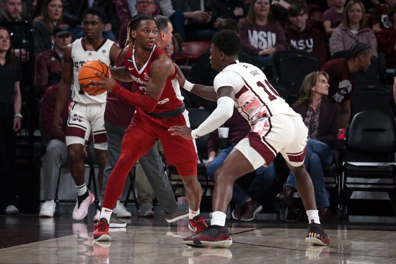 Feb 17, 2024; Starkville, Mississippi, USA; Arkansas Razorbacks guard El Ellis (3) handles the ball against Mississippi State Bulldogs guard Dashawn Davis (10) during the first half at Humphrey Coliseum. Mandatory Credit: Petre Thomagainst-USA TODAY Sports