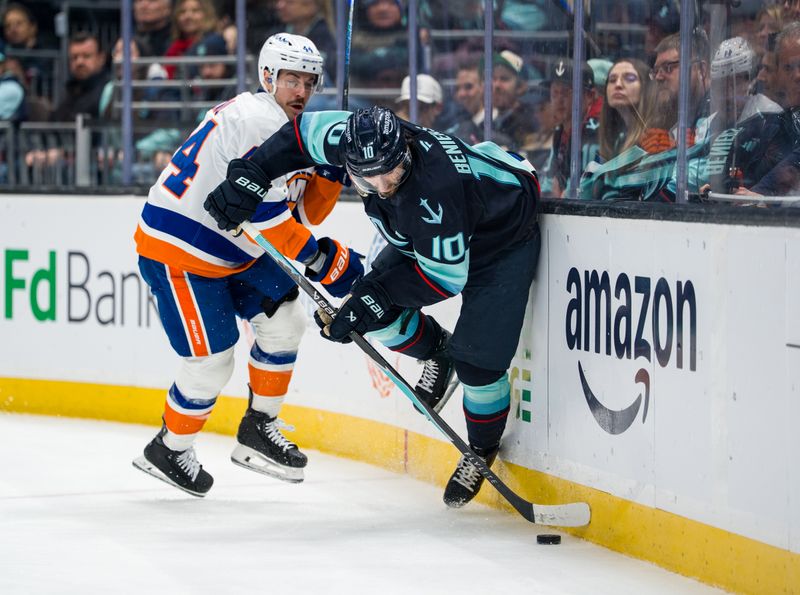 Jan 21, 2026; Seattle, Washington, USA; Seattle Kraken forward Matty Beniers (10) and New York Islanders forward Jean-Gabriel Pageau (44) battle for the puck during the second period  at Climate Pledge Arena. Mandatory Credit: Stephen Brashear-Imagn Images
