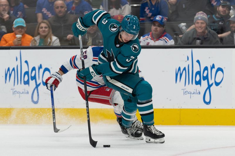 Jan 23, 2024; San Jose, California, USA; San Jose Sharks defenseman Henry Thrun (3) controls the puck during the first period against New York Rangers left wing Will Cuylle (50) at SAP Center at San Jose. Mandatory Credit: Stan Szeto-USA TODAY Sports