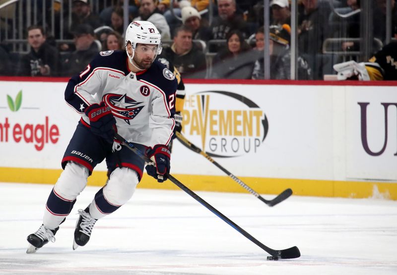 Jan 7, 2025; Pittsburgh, Pennsylvania, USA; Columbus Blue Jackets center Zachary Aston-Reese (27) skates with the puck against the Pittsburgh Penguins during the second period at PPG Paints Arena. Mandatory Credit: Charles LeClaire-Imagn Images