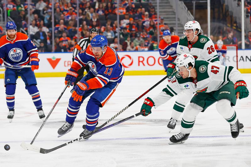 Feb 23, 2024; Edmonton, Alberta, CAN; Edmonton Oilers forward Mattias Janmark (13) carries the puck around Minnesota Wild defensemen Declan Chisholm (47) during the first period at Rogers Place. Mandatory Credit: Perry Nelson-USA TODAY Sports