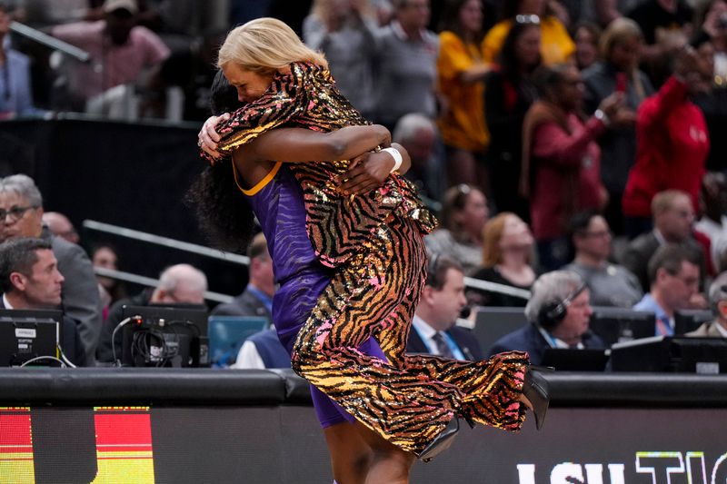 Apr 2, 2023; Dallas, TX, USA; LSU Lady Tigers guard Flau'jae Johnson (4) hugs head coach Kim Mulkey after defeating the Iowa Hawkeyes during the final round of the Women's Final Four NCAA tournament at the American Airlines Center. Mandatory Credit: Kirby Lee-USA TODAY Sports