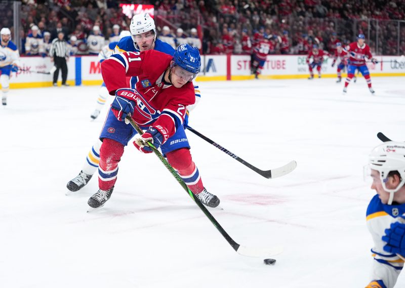 Jan 22, 2026; Montreal, Quebec, CAN;  Montreal Canadiens defenseman Kaiden Guhle (21) plays the puck against Buffalo Sabres defenseman Owen Power (25) during the third period at the Bell Centre. Mandatory Credit: Eric Bolte-Imagn Images