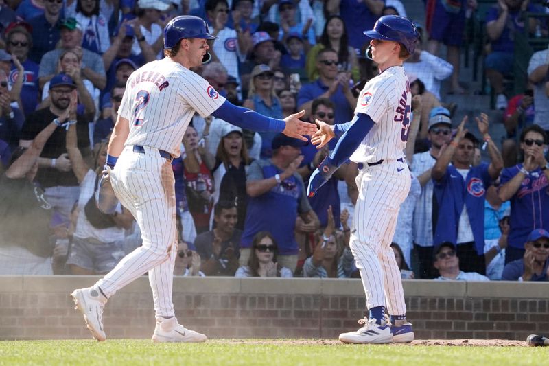 Sep 20, 2024; Chicago, Illinois, USA; Chicago Cubs outfielder Pete Crow-Armstrong (52) is greeted by second baseman Nico Hoerner (2) after scoring against the Washington Nationals during the seventh inning at Wrigley Field. Mandatory Credit: David Banks-Imagn Images