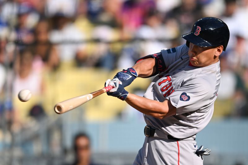 Jul 21, 2024; Los Angeles, California, USA; Boston Red Sox designated hitter Masataka Yoshida (7) singles against the Los Angeles Dodgers during the sixth inning at Dodger Stadium. Mandatory Credit: Jonathan Hui-USA TODAY Sports