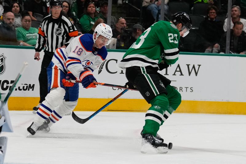 Feb 17, 2024; Dallas, Texas, USA;  Edmonton Oilers left wing Zach Hyman (18) and Dallas Stars defenseman Esa Lindell (23) chase the puck during the first period at American Airlines Center. Mandatory Credit: Chris Jones-USA TODAY Sports