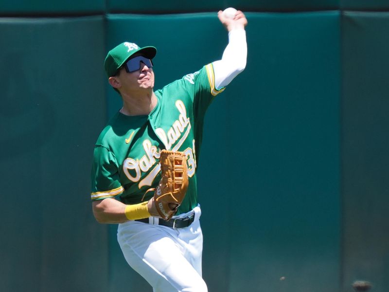 Jun 29, 2023; Oakland, California, USA; Oakland Athletics left fielder JJ Bleday (33) throws the ball infield against the New York Yankees during the fourth inning at Oakland-Alameda County Coliseum. Mandatory Credit: Kelley L Cox-USA TODAY Sports