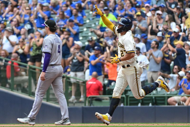 Aug 9, 2023; Milwaukee, Wisconsin, USA; Milwaukee Brewers shortstop Willy Adames (27) reacts after hitting a solo home run as Colorado Rockies first baseman Michael Toglia (4) looks on in the fifth inning at American Family Field. Mandatory Credit: Benny Sieu-USA TODAY Sports