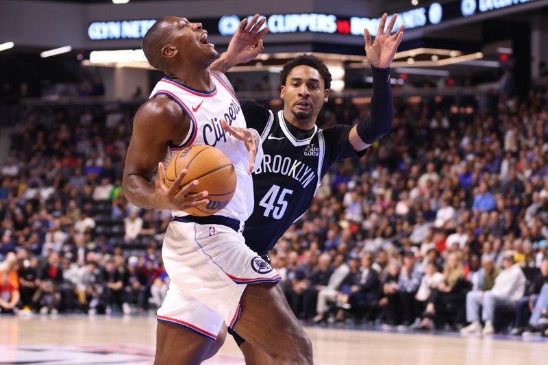 OCEANSIDE, CALIFORNIA - OCTOBER 08:    Kris Dunn #8 of the Los Angeles Clippers attacks against Keon Johnson #45 of the Brooklyn Nets during the preseason game at Frontwave Arena on October 08, 2024 in Oceanside, California. NOTE TO USER: User expressly acknowledges and agrees that, by downloading and or using this photograph, User is consenting to the terms and conditions of the Getty Images License Agreement. (Photo by Joe Scarnici/Getty Images)