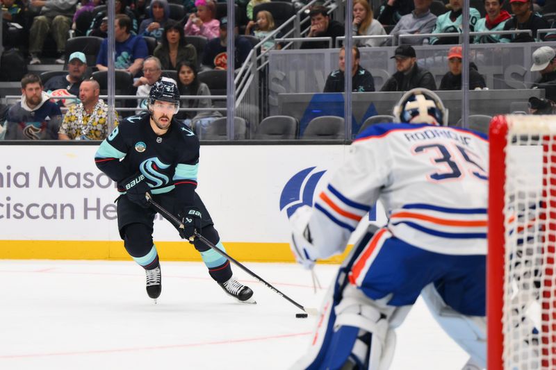 Oct 2, 2024; Seattle, Washington, USA; Seattle Kraken center Chandler Stephenson (9) advances the puck against the Edmonton Oilers during the third period at Climate Pledge Arena. Mandatory Credit: Steven Bisig-Imagn Images