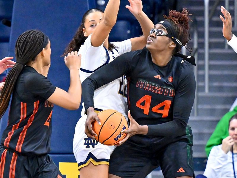 Jan 14, 2024; South Bend, Indiana, USA; Miami Hurricanes forward Kyla Oldacre (44) goes up for a shot as Notre Dame Fighting Irish forward Kylee Watson (22) defends in the first half at the Purcell Pavilion. Mandatory Credit: Matt Cashore-USA TODAY Sports