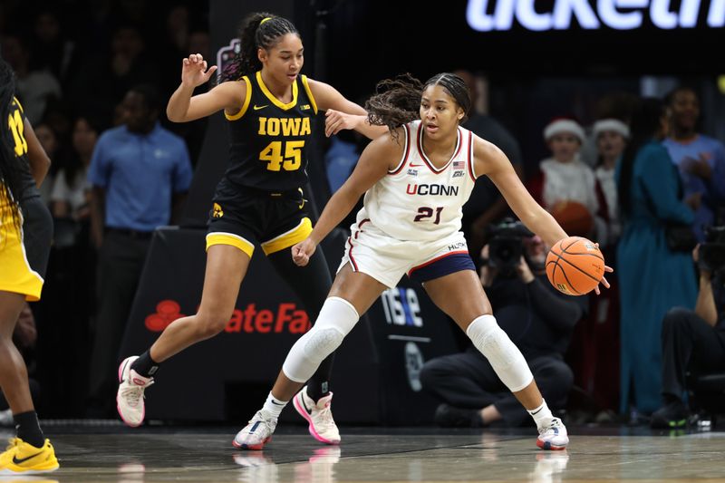 Dec 20, 2025; Brooklyn, New York, USA; UConn Huskies forward Sarah Strong (21) drives to the basket against Iowa Hawkeyes forward Hannah Stuelke (45) during the first half at Barclays Center. Mandatory Credit: Pamela Smith-Imagn Images