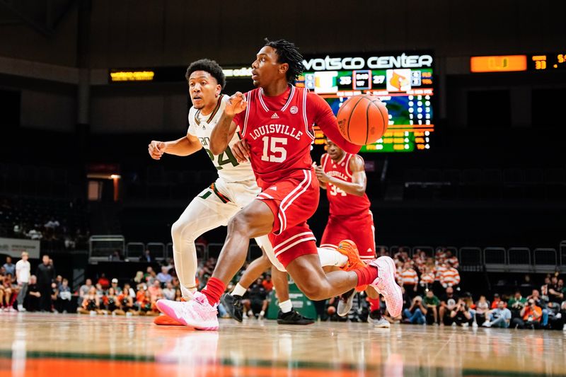 Feb 11, 2023; Coral Gables, Florida, USA; Louisville Cardinals guard Hercy Miller (15) dribbles the ball past Miami (Fl) Hurricanes guard Nijel Pack (24) during the first half at Watsco Center. Mandatory Credit: Rich Storry-USA TODAY Sports