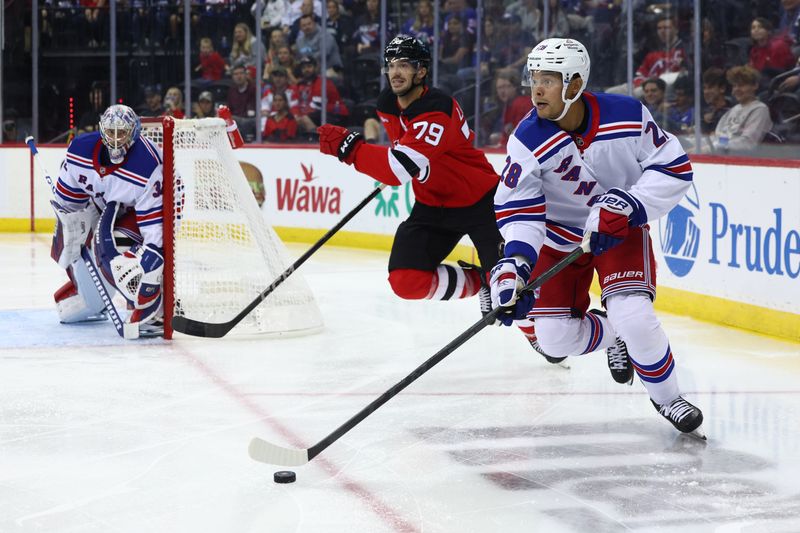 Sep 30, 2024; Newark, New Jersey, USA; New York Rangers defenseman Madison Bowey (28) skates with the puck against the New Jersey Devils during the second period at Prudential Center. Mandatory Credit: Ed Mulholland-Imagn Images