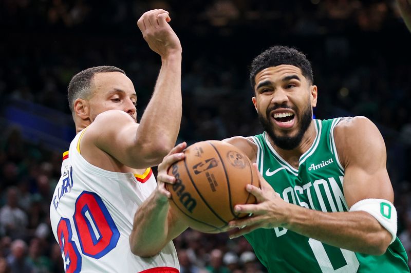 BOSTON, MA - NOVEMBER 6  Jayson Tatum #0 of the Boston Celtics drives to the basket past Stephen Curry #30 of the Golden State Warriors during the first quarter of a game at TD Garden on November 6, 2024 in Boston, Massachusetts. NOTE TO USER: User expressly acknowledges and agrees that, by downloading and or using this photograph, User is consenting to the terms and conditions of the Getty Images License Agreement. (Photo by Adam Glanzman/Getty Images)