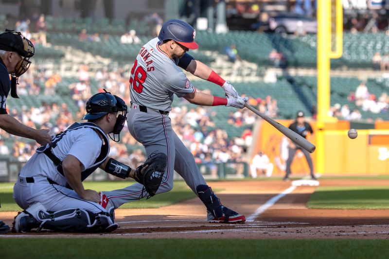 Jun 11, 2024; Detroit, Michigan, USA; Washington Nationals outfielder Lane Thomas (28) hits into a double play against the Detroit Tigers at Comerica Park. Mandatory Credit: David Reginek-USA TODAY Sports