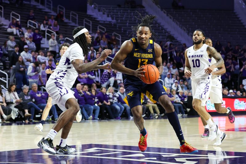 Mar 3, 2026; Manhattan, Kansas, USA; West Virginia Mountaineers guard Chance Moore (13) drives the lane against Kansas State Wildcats guard C.J. Jones (3) during the first half at Bramlage Coliseum. Mandatory Credit: Scott Sewell-Imagn Images