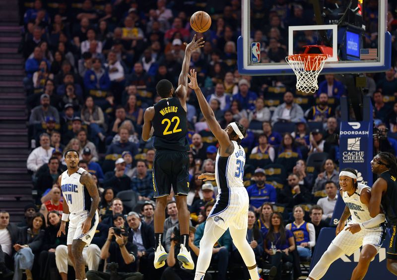 SAN FRANCISCO, CALIFORNIA - FEBRUARY 03:  Andrew Wiggins #22 of the Golden State Warriors shoots over Wendell Carter Jr. #34 of the Orlando Magic during the first half of an NBA basketball game at Chase Center on February 03, 2025 in San Francisco, California. NOTE TO USER: User expressly acknowledges and agrees that, by downloading and or using this photograph, User is consenting to the terms and conditions of the Getty Images License Agreement.  (Photo by Thearon W. Henderson/Getty Images)