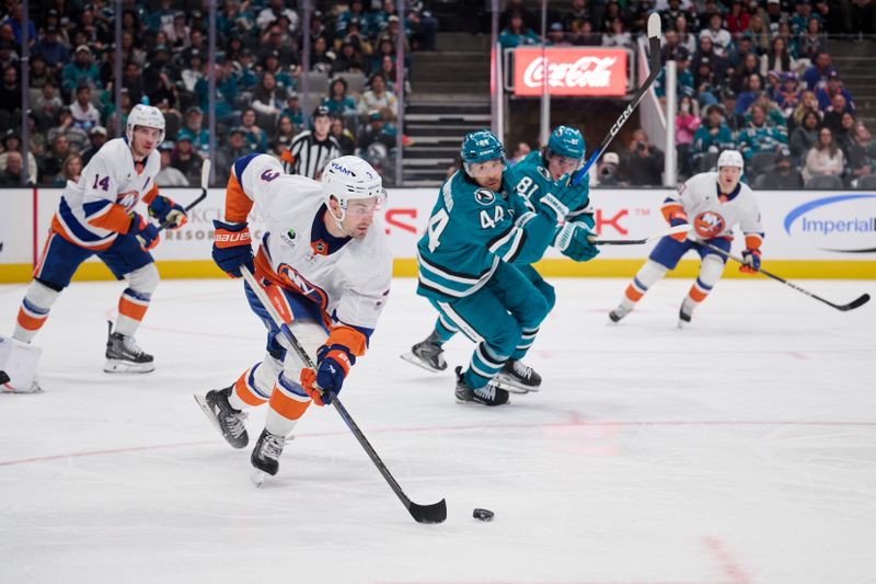 Mar 7, 2026; San Jose, California, USA; New York Islanders defenseman Adam Pelech (3) plays the puck against San Jose Sharks left wing Kiefer Sherwood (44) and right wing Adam Gaudette (81) during the second period  at SAP Center at San Jose. Mandatory Credit: Robert Edwards-Imagn Images