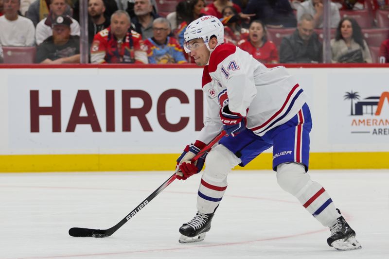 Feb 29, 2024; Sunrise, Florida, USA; Montreal Canadiens center Nick Suzuki (14) shoots the puck against the Florida Panthers during the first period at Amerant Bank Arena. Mandatory Credit: Sam Navarro-USA TODAY Sports