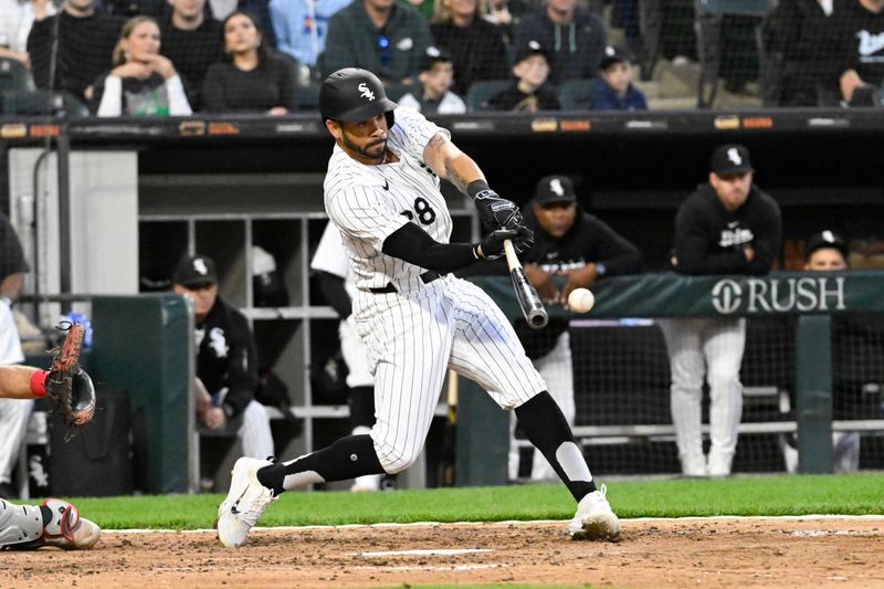 May 10, 2024; Chicago, Illinois, USA;  Chicago White Sox outfielder Tommy Pham (28) hits an RBI single against the Cleveland Guardians during the fifth inning at Guaranteed Rate Field. Mandatory Credit: Matt Marton-USA TODAY Sports