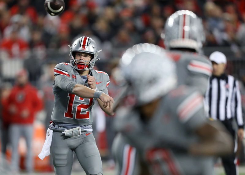 Nov 11, 2023; Columbus, Ohio, USA; Ohio State Buckeyes quarterback Lincoln Kienholz (12) throws a pass during the fourth quarter against the Michigan State Spartans at Ohio Stadium. Mandatory Credit: Joseph Maiorana-USA TODAY Sports