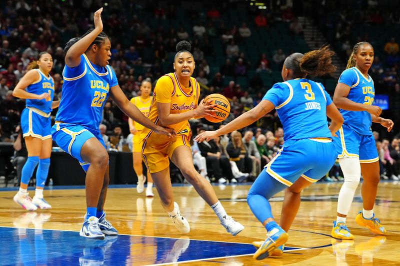 Mar 8, 2024; Las Vegas, NV, USA; USC Trojans guard JuJu Watkins (12) drives the lane between UCLA Bruins forward Christeen Iwuala (22) and UCLA Bruins guard Londynn Jones (3) during the third quarter at MGM Grand Garden Arena. Mandatory Credit: Stephen R. Sylvanie-USA TODAY Sports