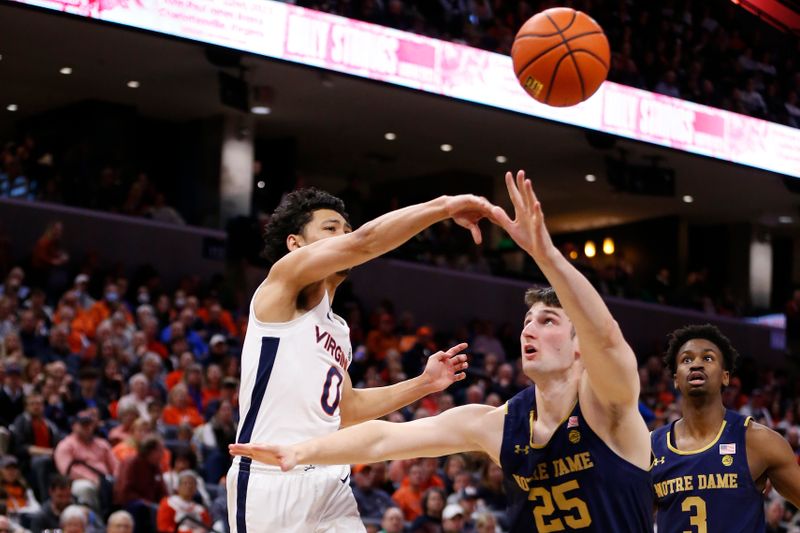 Feb 18, 2023; Charlottesville, Virginia, USA; Virginia Cavaliers guard Kihei Clark (0) passes the ball as Notre Dame Fighting Irish forward Matt Zona (25) defends during the second half at John Paul Jones Arena. Mandatory Credit: Amber Searls-USA TODAY Sports