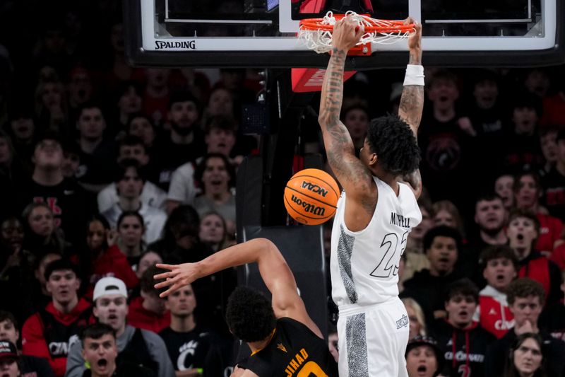 Jan 18, 2025; Cincinnati, Ohio, USA;  Cincinnati Bearcats forward Dillon Mitchell (23) dunks the ball over Arizona State Sun Devils forward Basheer Jihad (8) in the second half at Fifth Third Arena. Mandatory Credit: Aaron Doster-Imagn Images