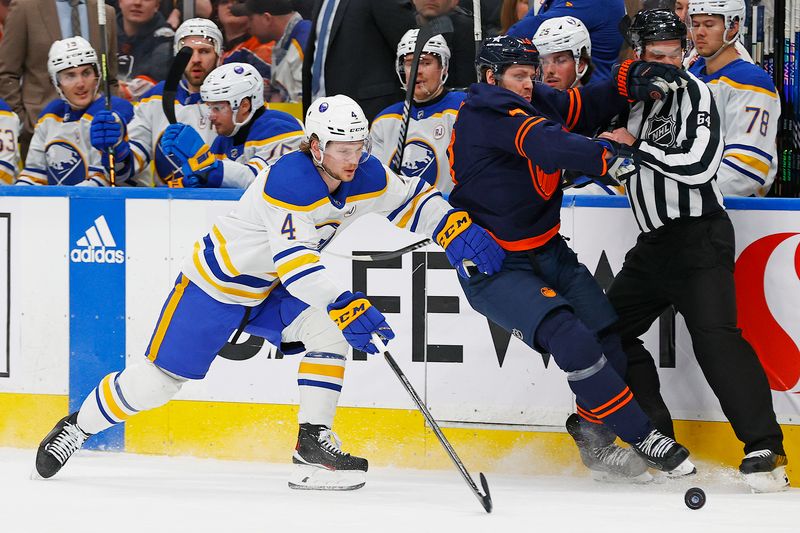 Mar 21, 2024; Edmonton, Alberta, CAN; Edmonton Oilers forward Mattias Janmark (13) and Buffalo Sabres defensemen Bowen Byron (4) Battle along the boards for a loose puck  during the first period at Rogers Place. Mandatory Credit: Perry Nelson-USA TODAY Sports