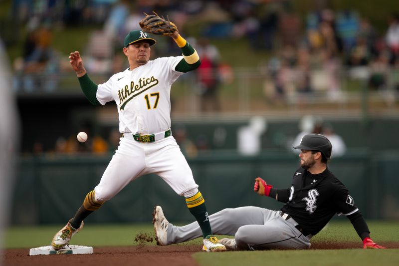 Apr 27, 2025; West Sacramento, California, USA; Athletics second baseman Luis Urías (17)  drops the ball while making the transfer after forcing out Chicago White Sox left fielder Andrew Benintendi (23) during the seventh inning at Sutter Health Park. Mandatory Credit: D. Ross Cameron-Imagn Images