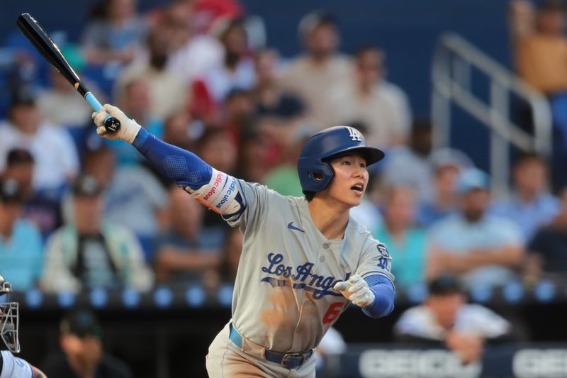 May 5, 2025; Miami, Florida, USA; Los Angeles Dodgers second baseman Hyeseong Kim (6) hits a single against the Miami Marlins during the eighth inning at loanDepot Park. Mandatory Credit: Sam Navarro-Imagn Images