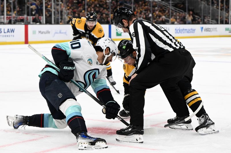 Nov 3, 2024; Boston, Massachusetts, USA; Boston Bruins center Charlie Coyle (13) breaks his stick in a face-off against Seattle Kraken center Matty Beniers (10) during the first period at the TD Garden. Mandatory Credit: Brian Fluharty-Imagn Images