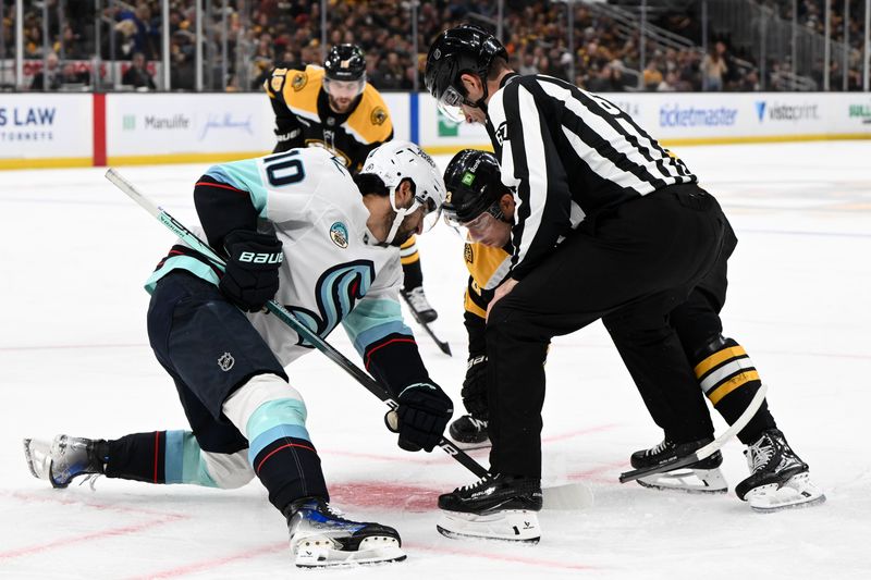 Nov 3, 2024; Boston, Massachusetts, USA; Boston Bruins center Charlie Coyle (13) breaks his stick in a face-off against Seattle Kraken center Matty Beniers (10) during the first period at the TD Garden. Mandatory Credit: Brian Fluharty-Imagn Images