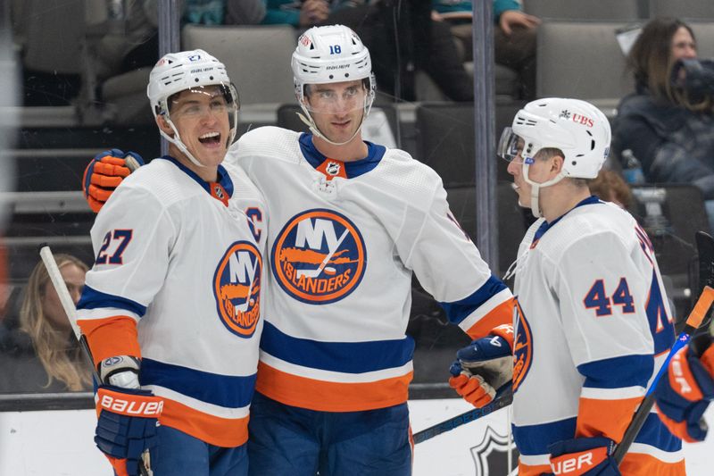 Mar 7, 2024; San Jose, California, USA; New York Islanders left wing Anders Lee (27) , left wing Pierre Engvall (18) and center Jean-Gabriel Pageau (44) celebrate during the third period against the San Jose Sharks at SAP Center at San Jose. Mandatory Credit: Stan Szeto-USA TODAY Sports