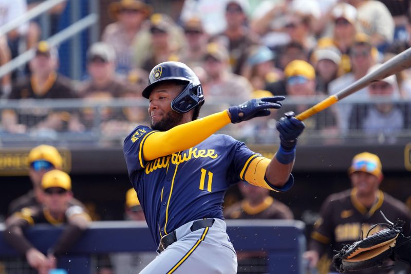 Feb 24, 2024; Peoria, Arizona, USA; Milwaukee Brewers center fielder Jackson Chourio (11) bats against the San Diego Padres during the first inning of a Spring Training game at Peoria Sports Complex. Mandatory Credit: Joe Camporeale-USA TODAY Sports