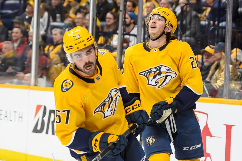 Nov 20, 2023; Nashville, Tennessee, USA;  Nashville Predators center Philip Tomasino (26) and Nashville Predators defenseman Dante Fabbro (57) react to the missed goal against the Colorado Avalanche during the third period at Bridgestone Arena. Mandatory Credit: Steve Roberts-USA TODAY Sports