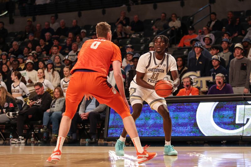 Jan 14, 2025; Atlanta, Georgia, USA; Georgia Tech Yellow Jackets forward Baye Ndongo (11) looks for the shot against Clemson Tigers center Viktor Lakhin (0) during the first half at McCamish Pavilion. Mandatory Credit: Jordan Godfree-Imagn Images