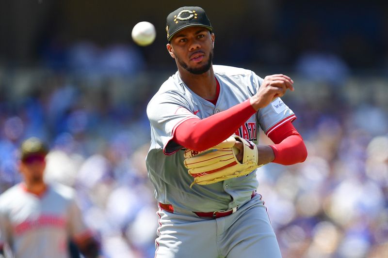 May 19, 2024; Los Angeles, California, USA; Cincinnati Reds pitcher Hunter Greene (21) throws to first for the out against Los Angeles Dodgers left fielder Teoscar Hernandez (37) during the sixth inning at Dodger Stadium. Mandatory Credit: Gary A. Vasquez-USA TODAY Sports