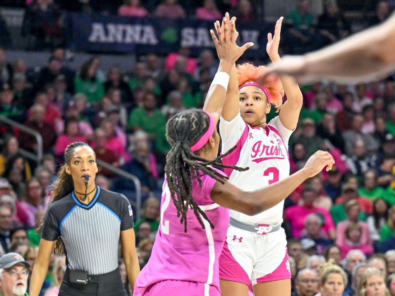 Feb 4, 2024; South Bend, Indiana, USA; Notre Dame Fighting Irish guard Hannah Hidalgo (3) shoots a three point basket over Pittsburgh Panthers forward Liatu King (2) in the second half at the Purcell Pavilion. Mandatory Credit: Matt Cashore-USA TODAY Sports