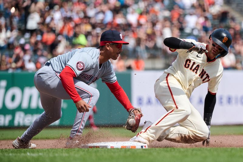 Apr 10, 2024; San Francisco, California, USA; San Francisco Giants shortstop Nick Ahmed (16) slides safely into third base against Washington Nationals third baseman Trey Lipscomb (38 during the sixth inning at Oracle Park. Mandatory Credit: Robert Edwards-USA TODAY Sports