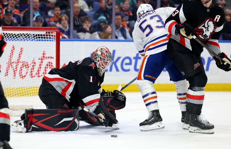 Mar 10, 2025; Buffalo, New York, USA;  Edmonton Oilers center Jeff Skinner (53) looks for a rebound as ]Buffalo Sabres goaltender Ukko-Pekka Luukkonen (1) makes a save during the first period at KeyBank Center. Mandatory Credit: Timothy T. Ludwig-Imagn Images