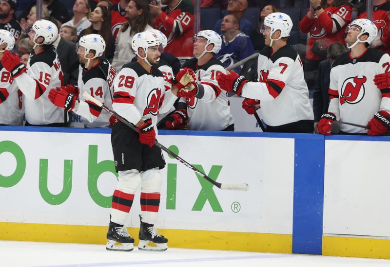 Oct 11, 2025; Tampa, Florida, USA; New Jersey Devils right wing Timo Meier (28) is congratulated after he scored a goal against the Tampa Bay Lightning during the first period at Benchmark International Arena. Mandatory Credit: Kim Klement Neitzel-Imagn Images