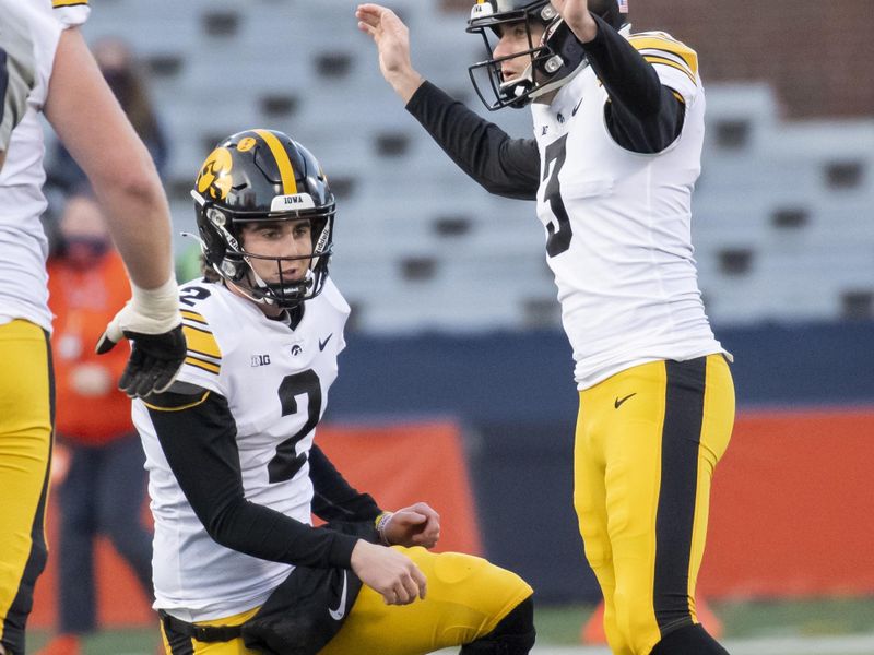 Dec 5, 2020; Champaign, Illinois, USA; Iowa Hawkeyes kicker Keith Duncan (3) celebrates his successful field goal with place kicker Ryan Gersonde (2) during the first half against the Illinois Fighting Illini at Memorial Stadium. Mandatory Credit: Patrick Gorski-USA TODAY Sports