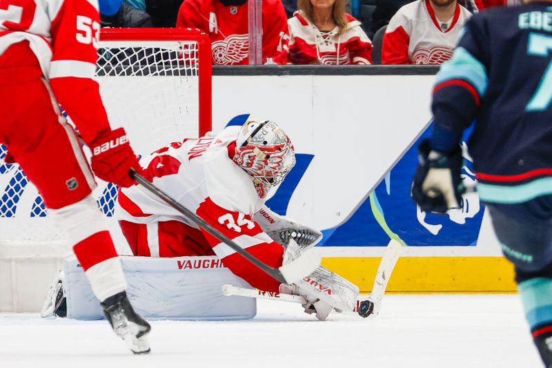 Feb 19, 2024; Seattle, Washington, USA; Detroit Red Wings goaltender Alex Lyon (34) makes a save against the Seattle Kraken during the third period at Climate Pledge Arena. Mandatory Credit: Joe Nicholson-USA TODAY Sports