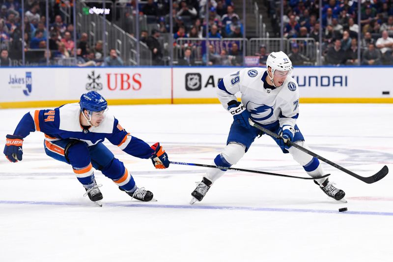 Apr 6, 2023; Elmont, New York, USA; Tampa Bay Lightning center Ross Colton (79) skates across the blue line defended by New York Islanders center Jean-Gabriel Pageau (44) during the first period at UBS Arena. Mandatory Credit: Dennis Schneidler-USA TODAY Sports