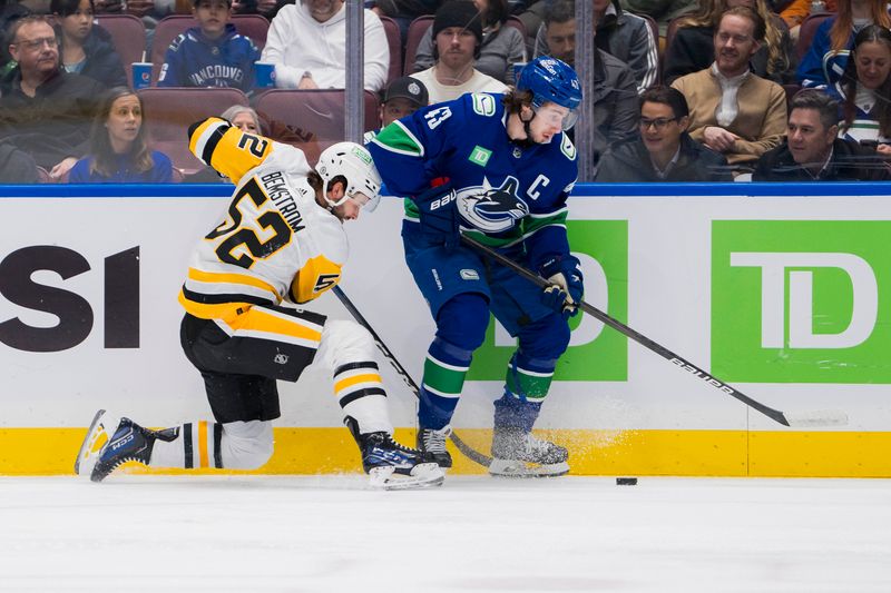 Feb 27, 2024; Vancouver, British Columbia, CAN; Pittsburgh Penguins forward Emil Bemstrom (52) battles with Vancouver Canucks defenseman Quinn Hughes (43) in the first period at Rogers Arena. Mandatory Credit: Bob Frid-USA TODAY Sports