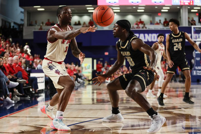 Jan 14, 2024; Boca Raton, Florida, USA; Florida Atlantic Owls guard Johnell Davis (1) passes the basketball as UAB Blazers guard Alejandro Vasquez (10) defends during the second half at Eleanor R. Baldwin Arena. Mandatory Credit: Sam Navarro-USA TODAY Sports