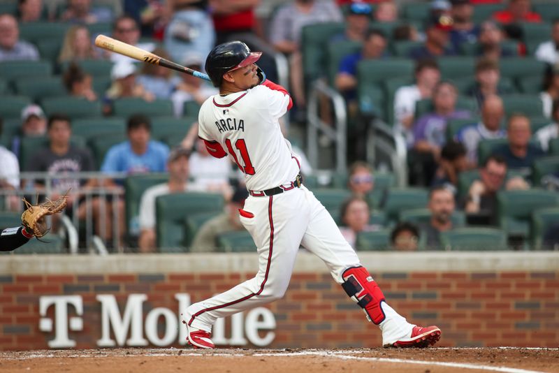 Aug 1, 2024; Atlanta, Georgia, USA; Atlanta Braves shortstop Orlando Arcia (11) hits a home run against the Miami Marlins in the third inning at Truist Park. Mandatory Credit: Brett Davis-USA TODAY Sports
