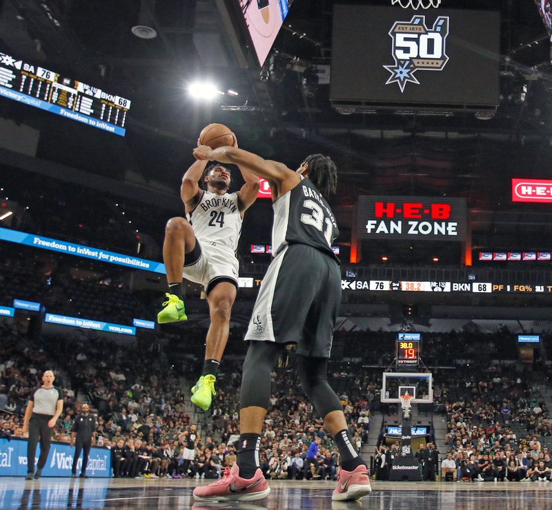 SAN ANTONIO, TX - JANUARY 17:  Cam Thomas #24 of the Brooklyn Nets shots over Keita Bates-Diop #31 of the San Antonio Spurs in the first half at AT&T Center on January 17, 2023 in San Antonio, Texas. NOTE TO USER: User expressly acknowledges and agrees that, by downloading and or using this photograph, User is consenting to terms and conditions of the Getty Images License Agreement. (Photo by Ronald Cortes/Getty Images)